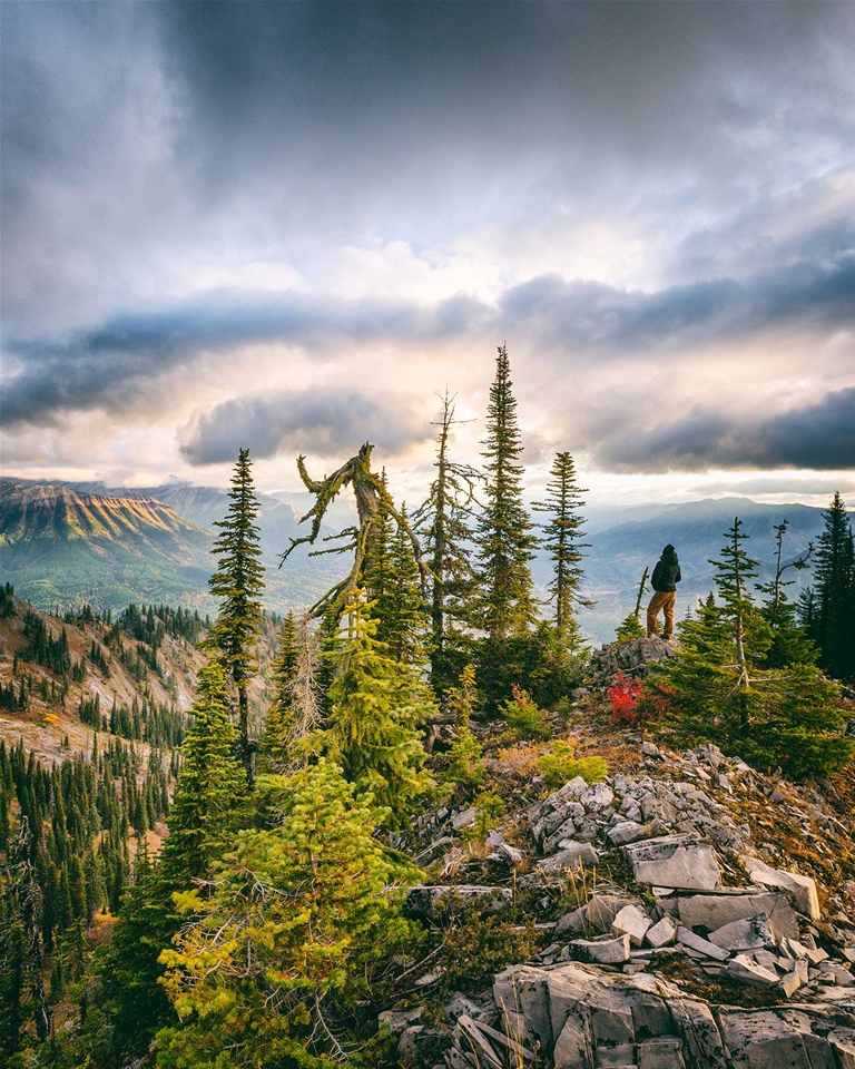 Hiker on the Lizard Range overlooking Fernie, Fall season