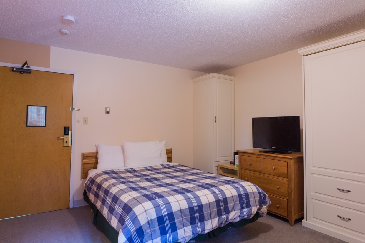 Compact Hotel Room at Griz Inn